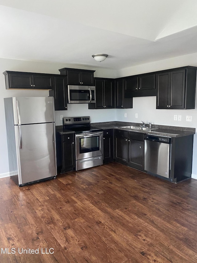 9078 Mallard Park Blvd, Walls, MS 38680 - kitchen featuring stainless steel appliances, dark cabinetry, dark countertops, and dark wood-type flooring
