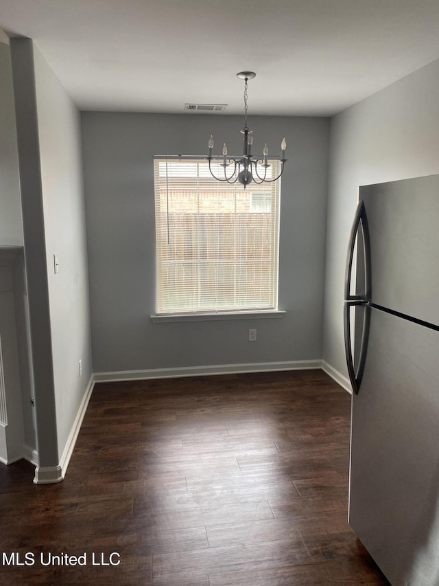 9078 Mallard Park Blvd, Walls, MS 38680 - unfurnished dining area with a chandelier, dark wood-type flooring, and baseboards