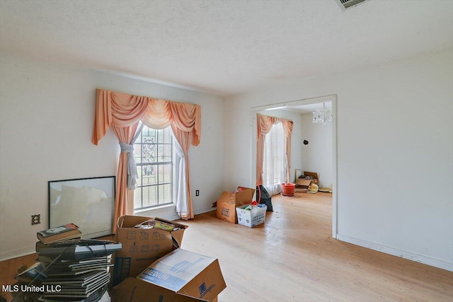 misc room featuring light hardwood / wood-style floors and a textured ceiling