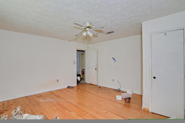 unfurnished room featuring ceiling fan, a textured ceiling, and hardwood / wood-style flooring