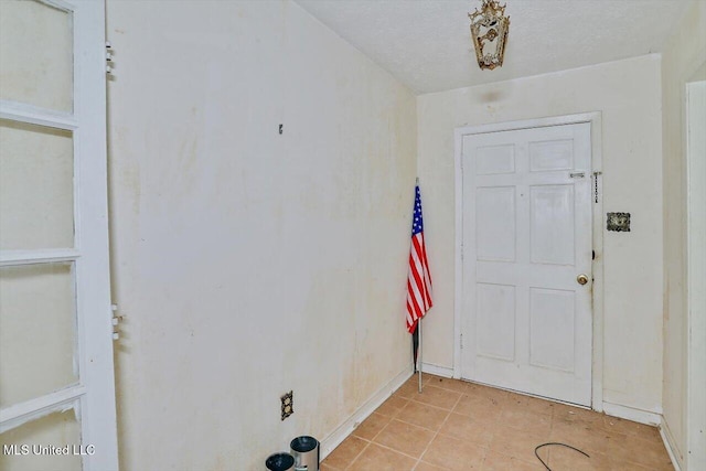 entryway with a textured ceiling