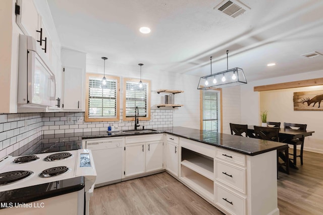 118 Dogwood Trl, Brandon, MS 39047 - kitchen featuring open shelves, white appliances, a sink, a peninsula, and recessed lighting