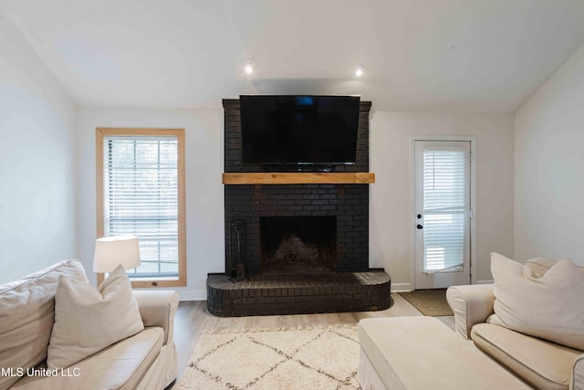 118 Dogwood Trl, Brandon, MS 39047 - living room with healthy amount of natural light, a brick fireplace, baseboards, and wood finished floors