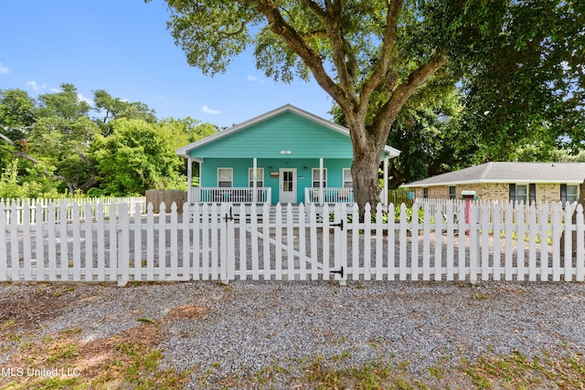 223 Sycamore St, Bay Saint Louis, MS 39520 - bungalow-style home with a porch and a fenced front yard