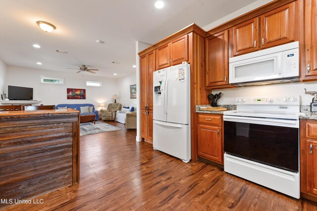 223 Sycamore St, Bay Saint Louis, MS 39520 - kitchen with open floor plan, dark wood-style flooring, brown cabinets, and white appliances