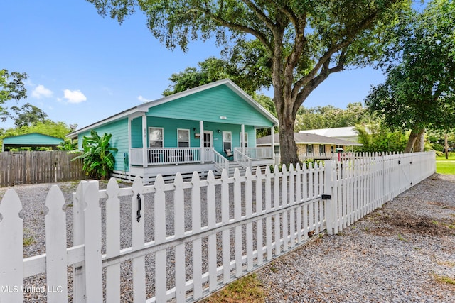 223 Sycamore St, Bay Saint Louis, MS 39520 - bungalow-style home with a porch, a fenced front yard, and a gate