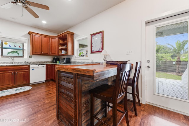 223 Sycamore St, Bay Saint Louis, MS 39520 - kitchen with dark wood-style flooring, open shelves, brown cabinets, dishwasher, and a sink