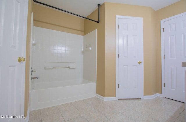 bathroom with tiled shower / bath and tile patterned floors