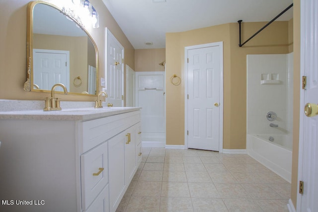 bathroom with washtub / shower combination, tile patterned floors, and vanity