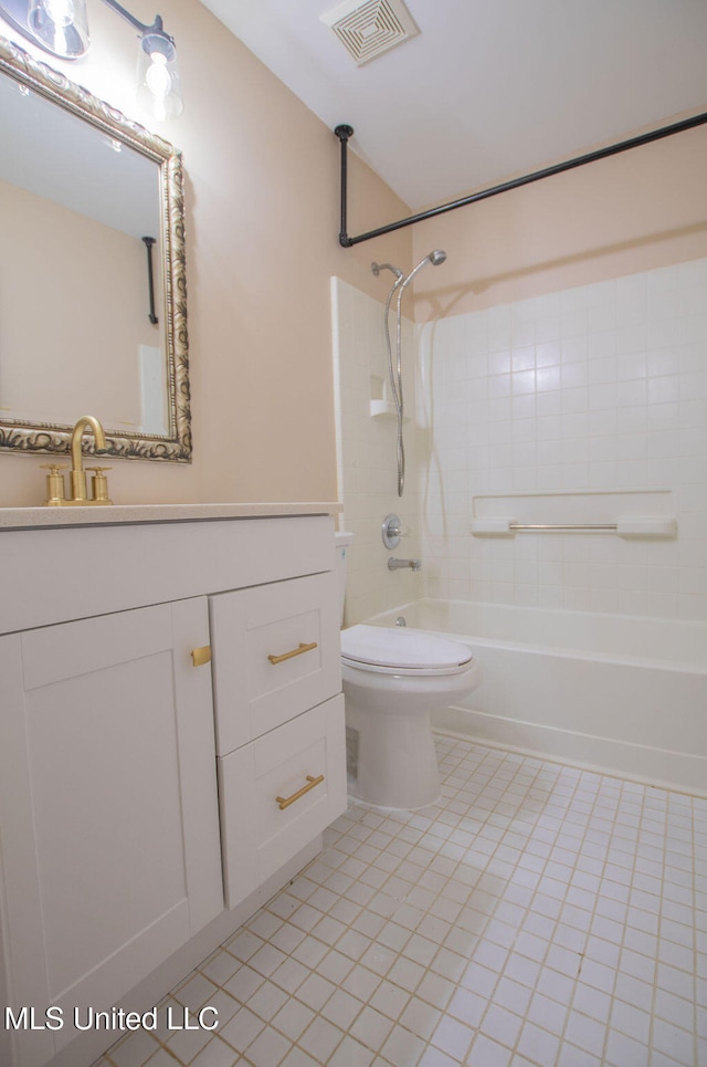 full bathroom with vanity, tile patterned floors, toilet, and tiled shower / bath combo