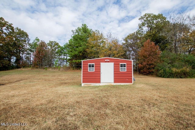 view of outbuilding with a yard