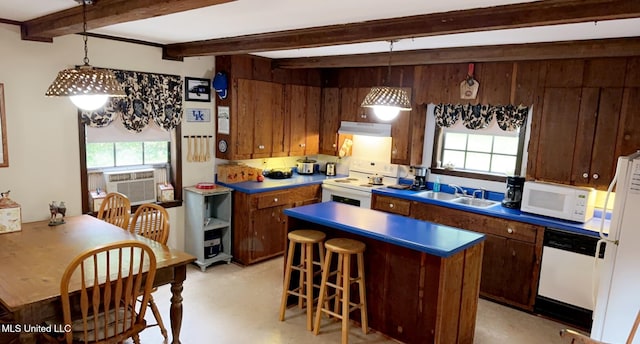 kitchen featuring beam ceiling, a sink, wooden walls, white appliances, and under cabinet range hood