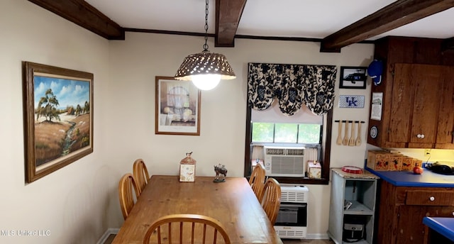 dining space with heating unit, ornamental molding, and beam ceiling