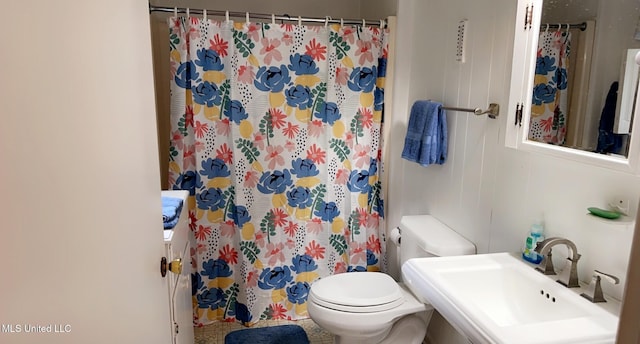 full bath with a sink, toilet, and a shower with curtain