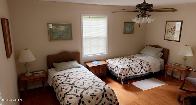 bedroom featuring a ceiling fan and wood finished floors