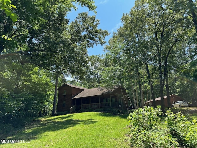 view of yard featuring covered porch