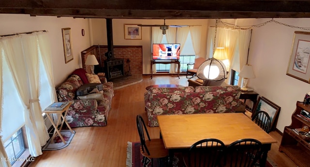 dining area featuring wood finished floors and a wood stove