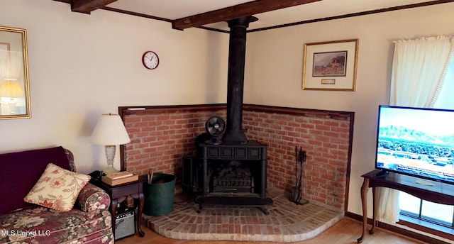 living room featuring a wood stove and beamed ceiling