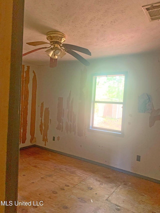 1356 Old River Rd, Harrisville, MS 39082 - unfurnished room featuring baseboards, a ceiling fan, and a textured ceiling