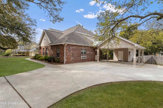 view of home's exterior featuring a lawn and a carport