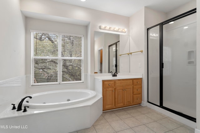 bathroom with vanity, tile patterned flooring, and plus walk in shower