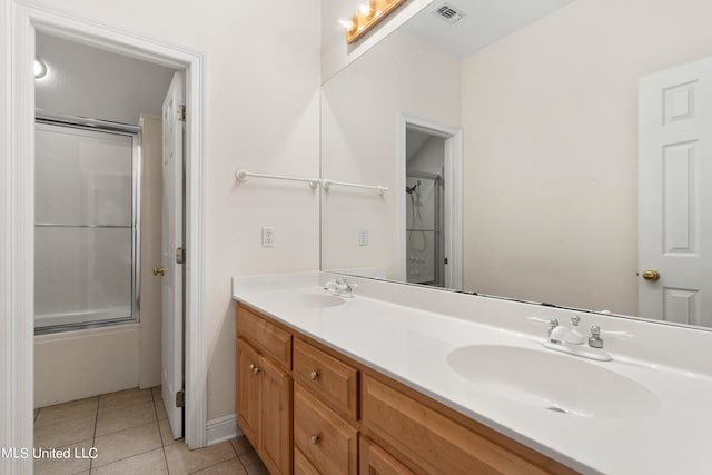 bathroom with vanity, enclosed tub / shower combo, and tile patterned floors