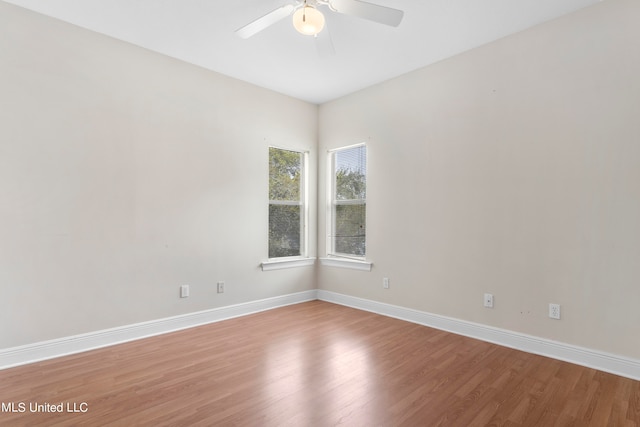 unfurnished room featuring hardwood / wood-style flooring and ceiling fan