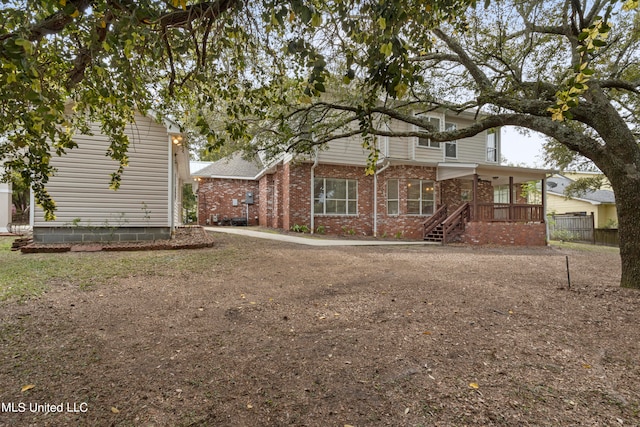 back of property with covered porch