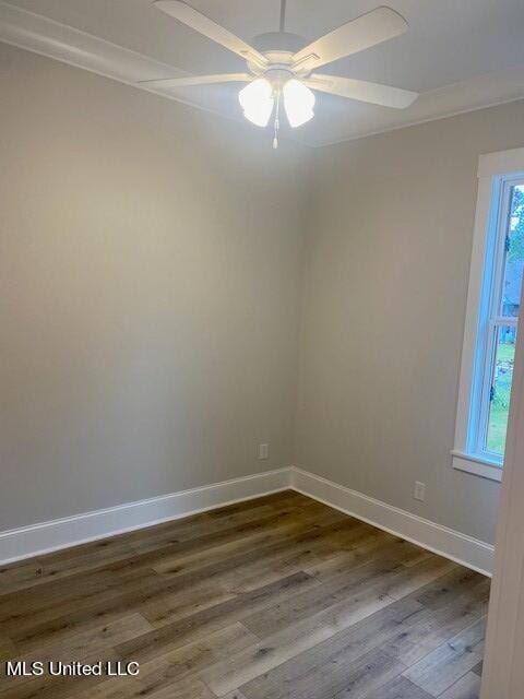 empty room with ornamental molding, wood-type flooring, and ceiling fan