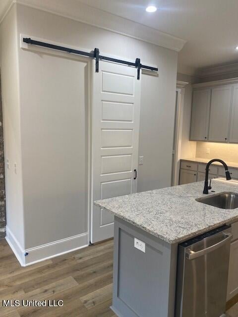 kitchen featuring dishwasher, sink, dark wood-type flooring, and gray cabinetry