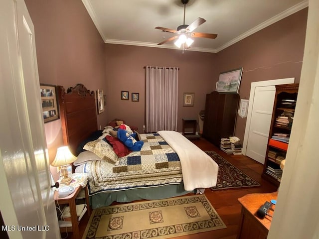 bedroom featuring a ceiling fan, ornamental molding, and wood finished floors