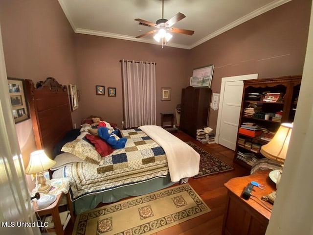 bedroom featuring ceiling fan, ornamental molding, and wood finished floors