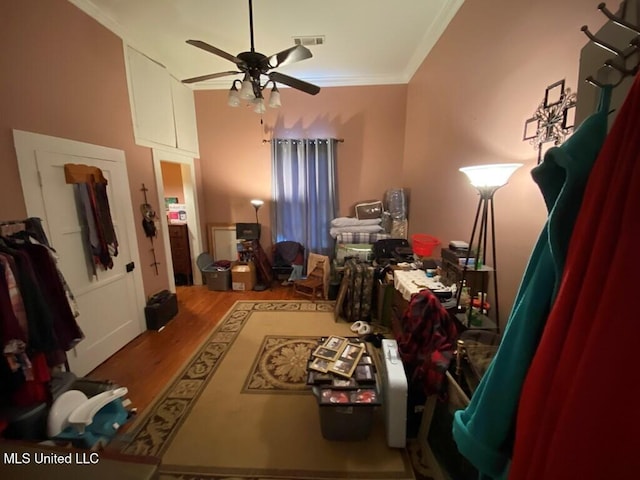 office area featuring ornamental molding, wood finished floors, visible vents, and a ceiling fan