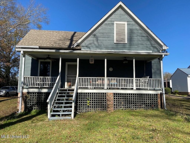 view of front of house with ceiling fan, a porch, fence, stairway, and a front yard