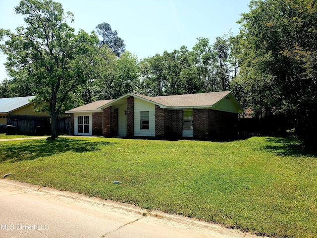 single story home with brick siding and a front yard