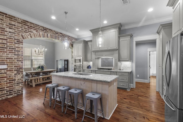 213 Wellington Way, Brandon, MS 39047 - kitchen with appliances with stainless steel finishes, a sink, gray cabinets, a chandelier, and ornamental molding