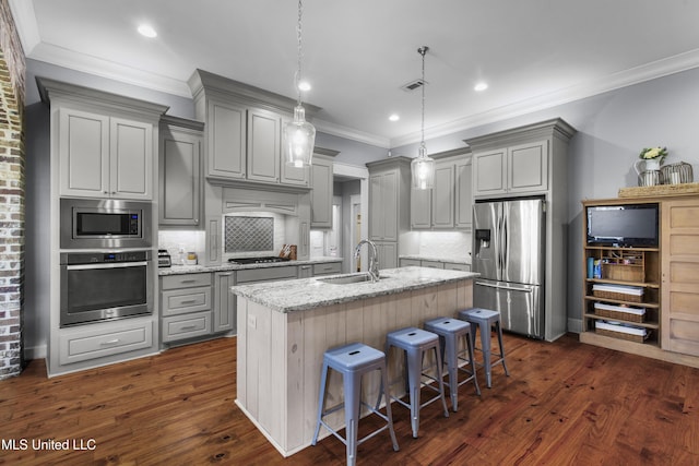 213 Wellington Way, Brandon, MS 39047 - kitchen with appliances with stainless steel finishes, gray cabinets, a sink, a center island with sink, and tasteful backsplash