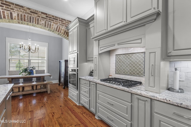 213 Wellington Way, Brandon, MS 39047 - kitchen featuring appliances with stainless steel finishes, gray cabinetry, and a chandelier