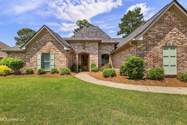 213 Wellington Way, Brandon, MS 39047 - view of front of home with brick siding, a front yard, and roof with shingles