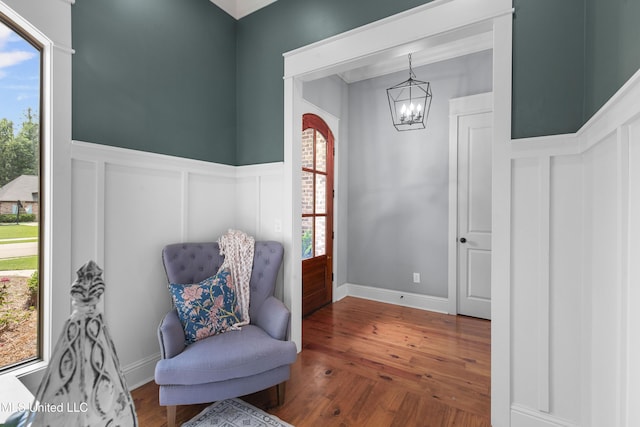 213 Wellington Way, Brandon, MS 39047 - living area featuring a chandelier, a decorative wall, a wainscoted wall, wood finished floors, and plenty of natural light