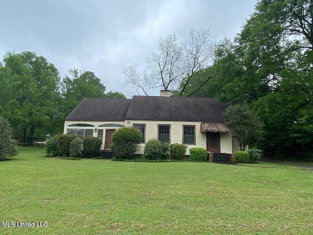 view of front of home with entry steps and a front yard