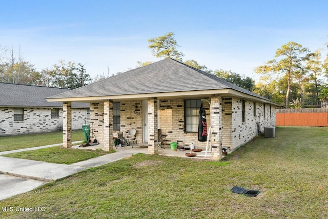 view of front of property with central AC unit, a patio area, and a front yard