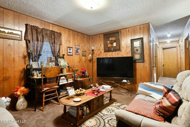 living room featuring light carpet, a textured ceiling, and wood walls