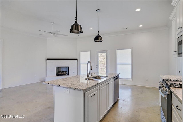 kitchen with pendant lighting, crown molding, appliances with stainless steel finishes, white cabinetry, and an island with sink