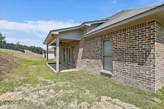 view of home's exterior featuring a patio area and a lawn