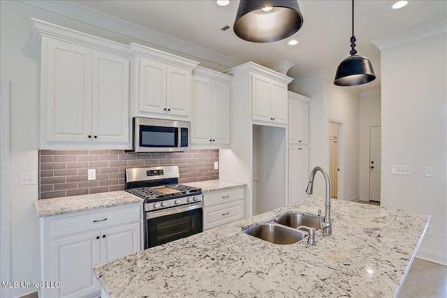 kitchen featuring white cabinetry, stainless steel appliances, sink, and tasteful backsplash