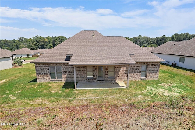 back of property featuring a patio and a lawn