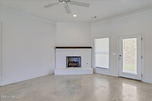 unfurnished living room with ornamental molding, a brick fireplace, and ceiling fan