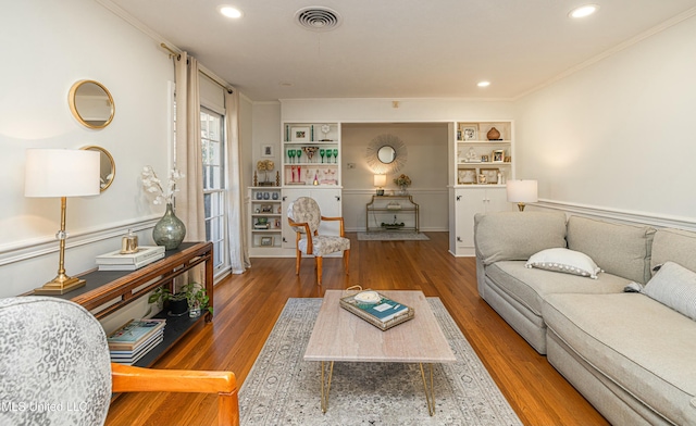 living room featuring crown molding, visible vents, wood finished floors, and recessed lighting