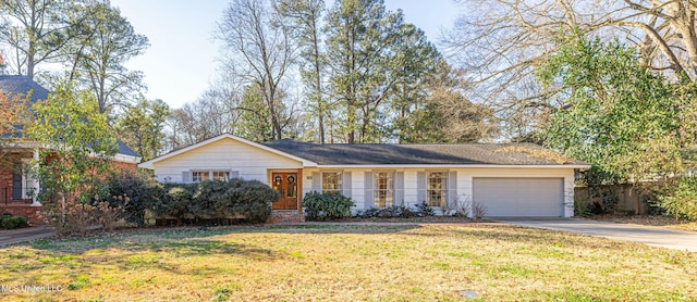 ranch-style home with a garage, driveway, and a front yard